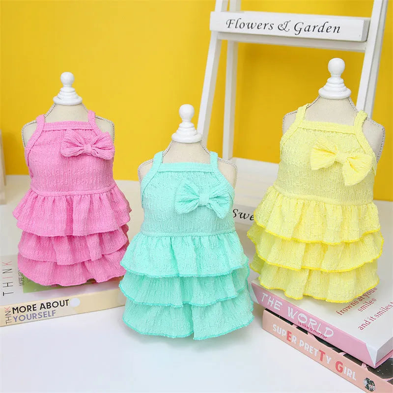 Pet dog princess dress for small dogs including thin teddy bichon breeds featuring a candy layered skirt style available in rose red yellow and water green colours made from polyester fabric in sizes S M L XL and XXL