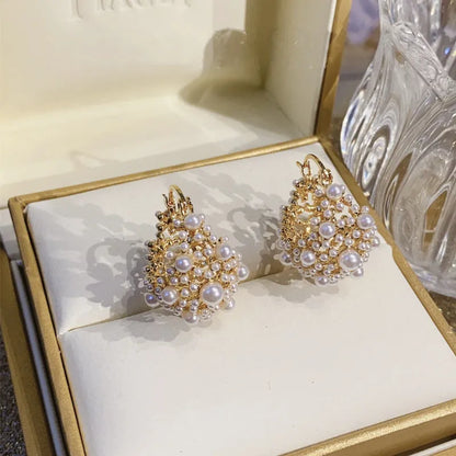 Gold-colour copper flower basket earrings with small rice-shaped bead inlay detail.
