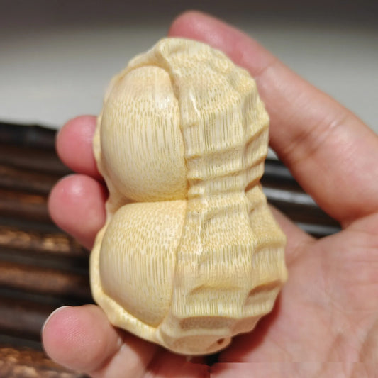 Hand-carved solid bamboo peanut ornament with modern design for gifting and decor