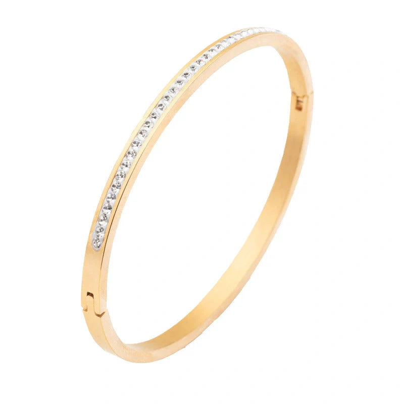 Elegant stainless steel bracelet with diamond accent, available in gold, rose gold, and steel finishes.