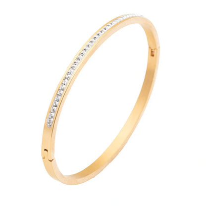 Elegant stainless steel bracelet with diamond accent, available in gold, rose gold, and steel finishes.