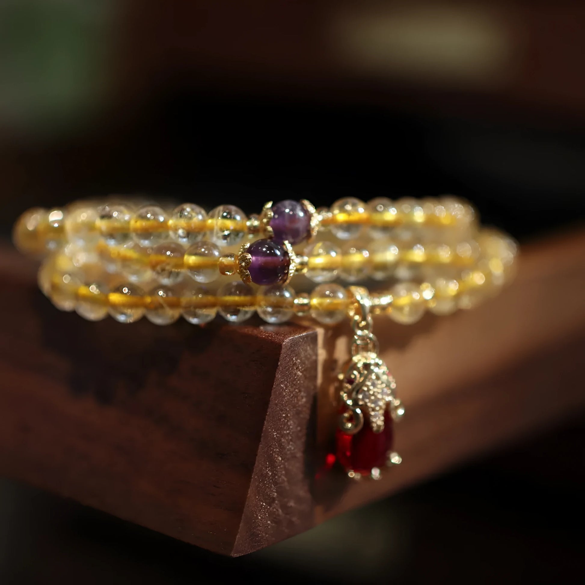 Close-up of a natural gold rutilated quartz bracelet with a Chinese style three-circle design.