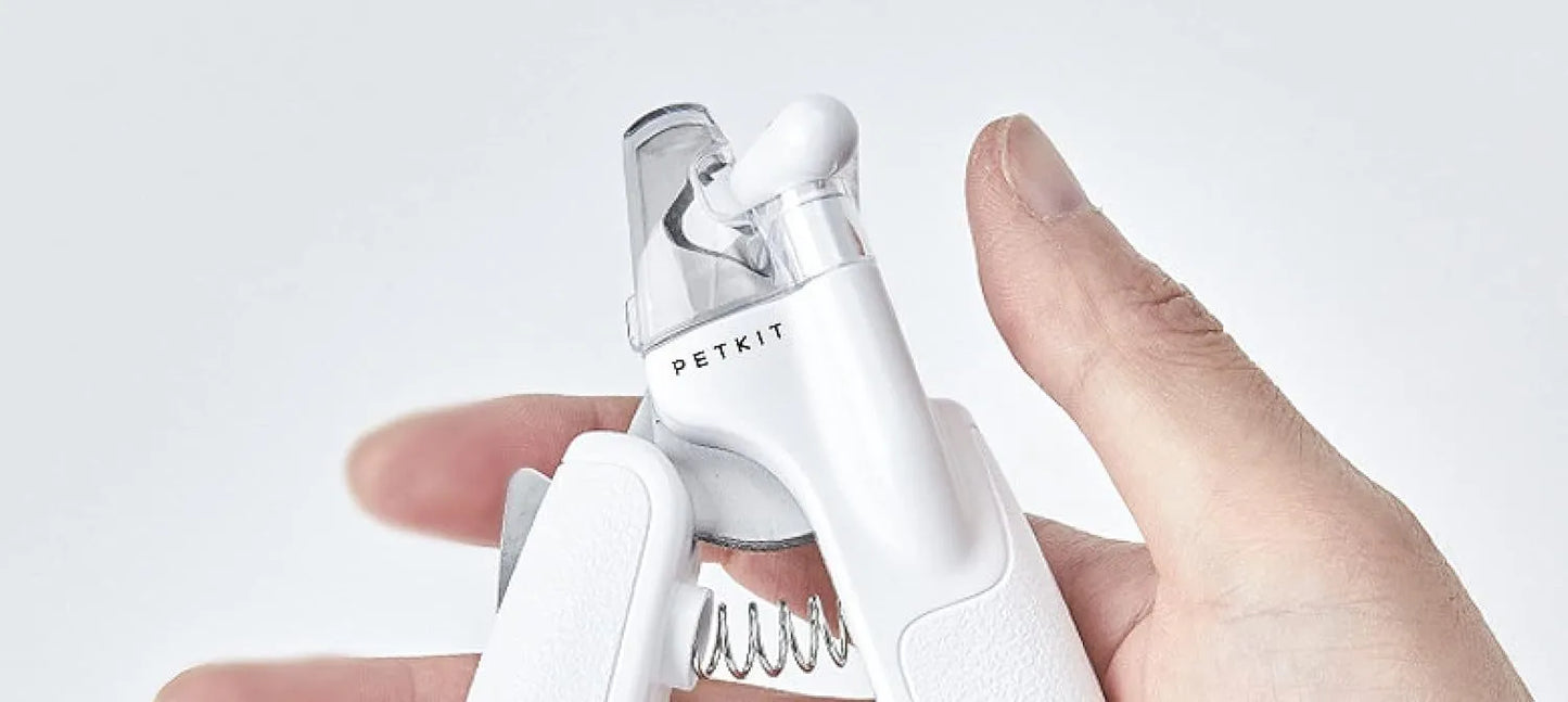 White pet nail clippers with LED light, anti-splash guard, and built-in nail file on a flat surface.
