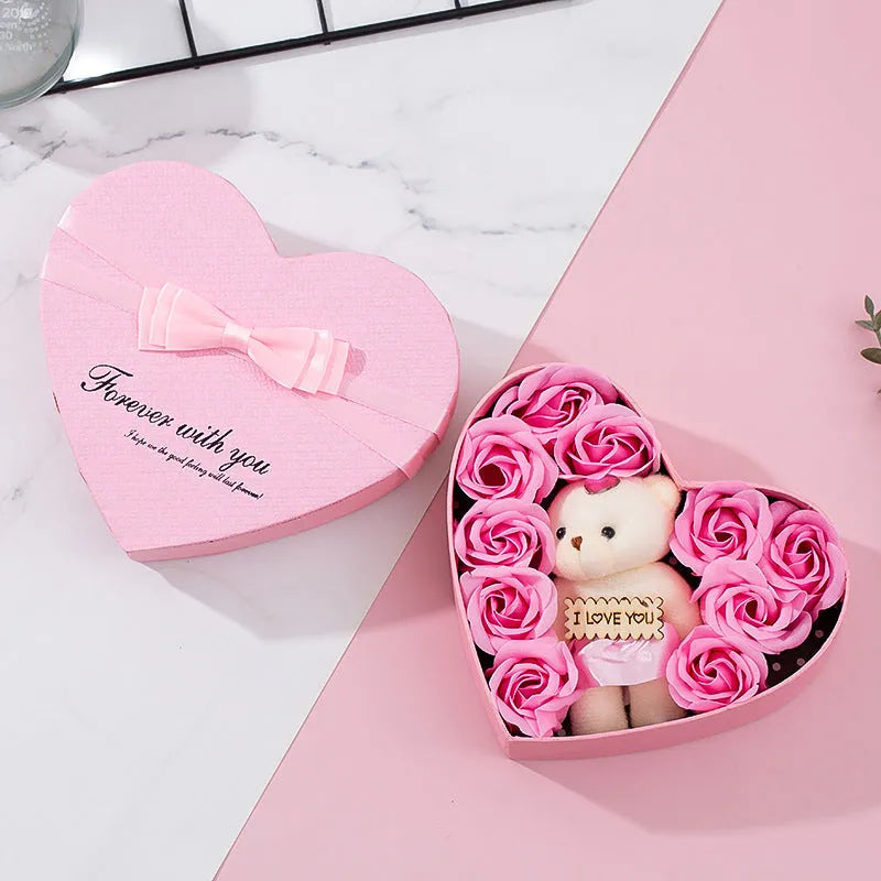 Red heart-shaped gift box open to reveal soap roses inside.