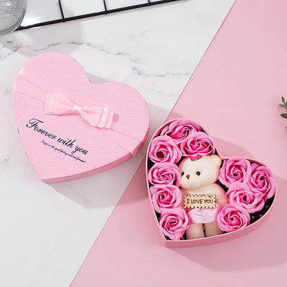 Red heart-shaped gift box open to reveal soap roses inside.