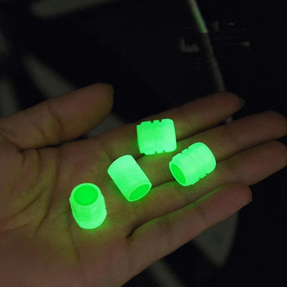 Set of four luminous rubber valve caps for car tyres showing glow effect