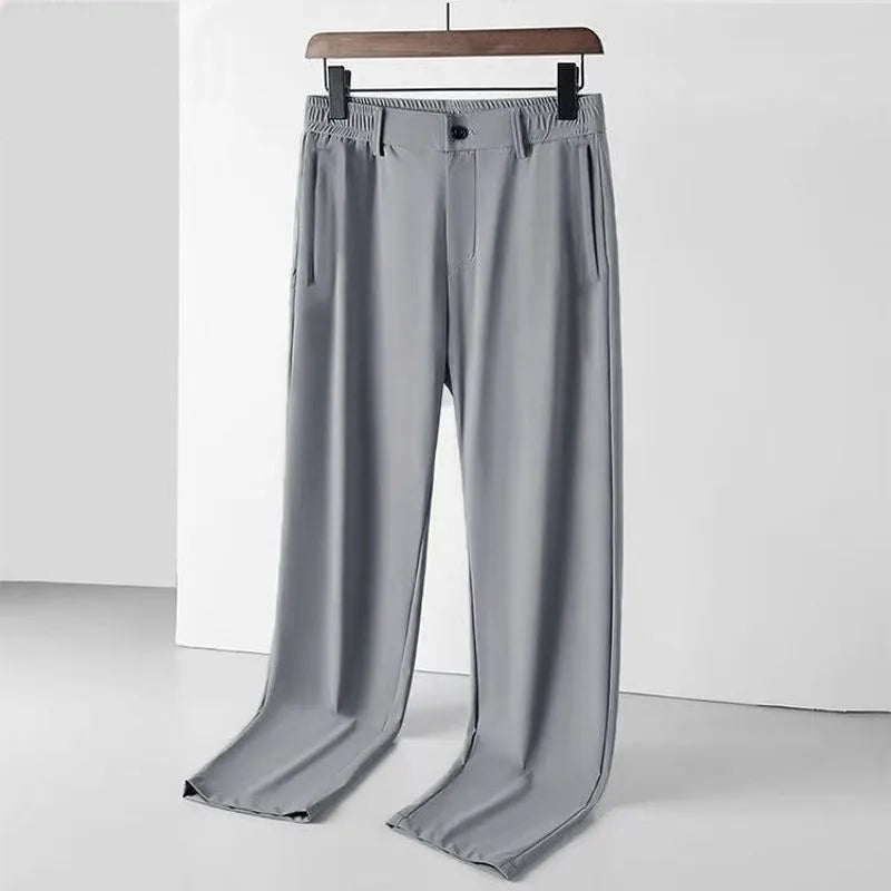 Men's black Ice Silk straight leg leisure trousers with elastic waistband laid flat