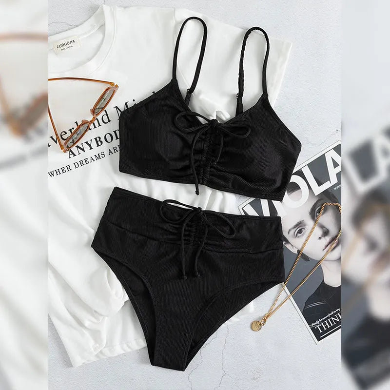 Black women's bikini with high waist and sling split design, shown as a two-piece set.