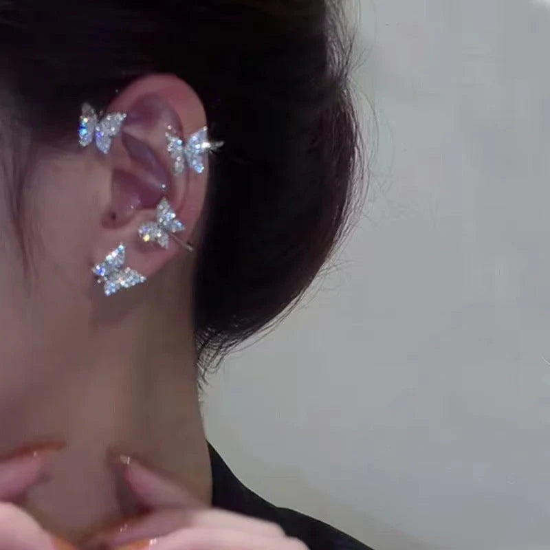 Fashionable butterfly-shaped ear clips in gold and silver tones, showcasing a chic, European-inspired design.