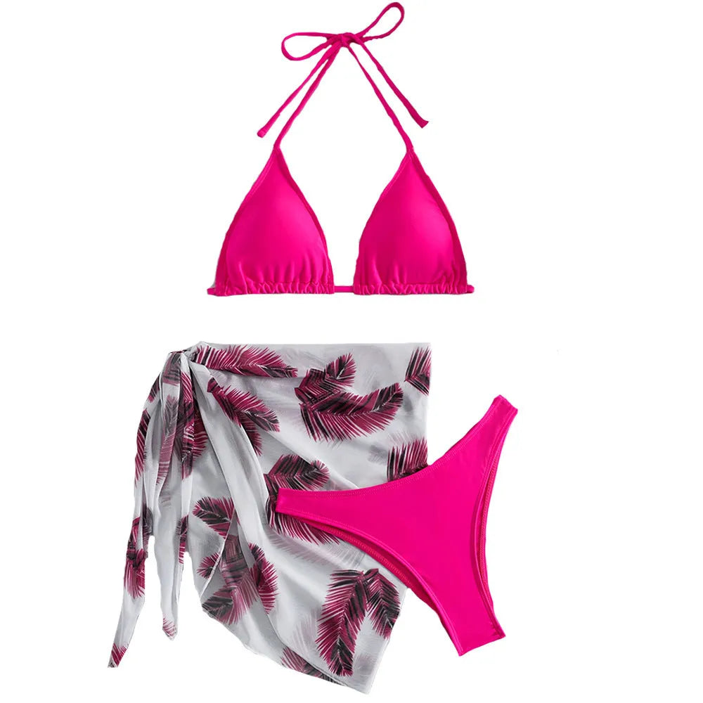 Women's orange three-piece bikini swimsuit with a matching printed gauze skirt laid flat.