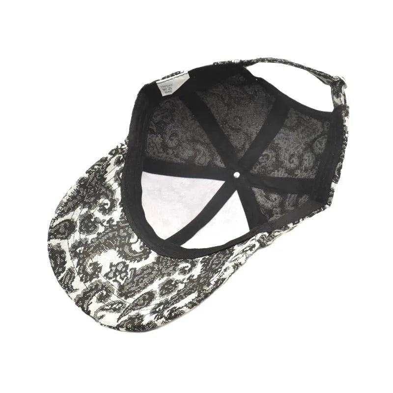 Blue polyester baseball cap with white paisley pattern print, showing dome crown style.