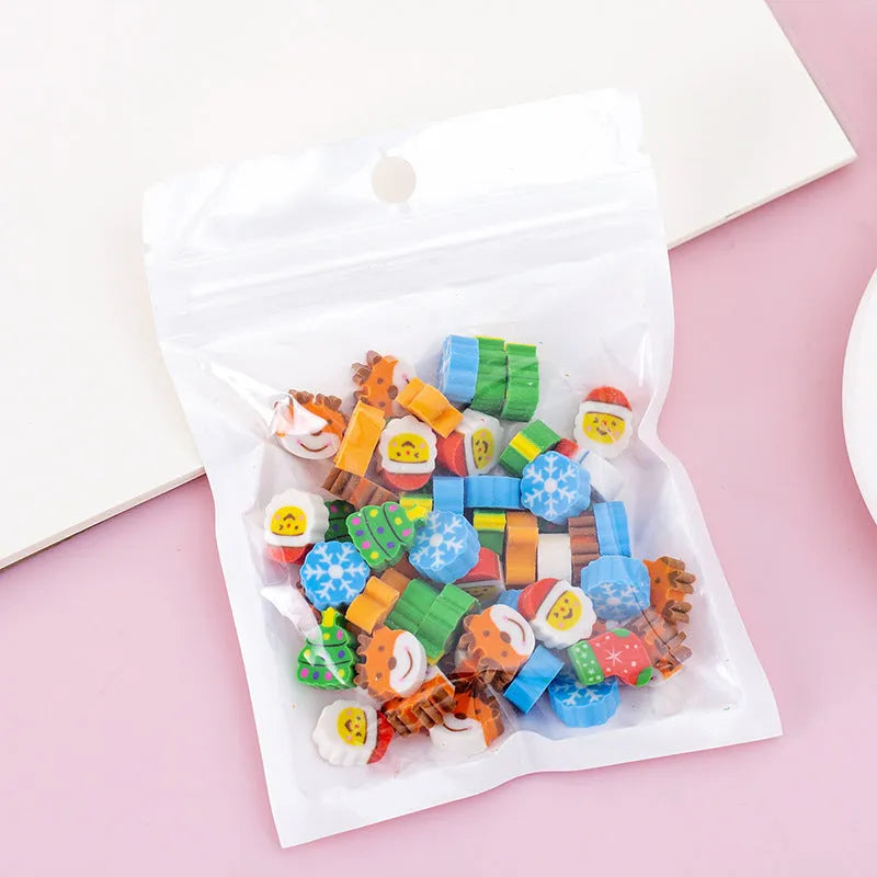 Assortment of 50 small cartoon erasers in pearlescent bags, showing fruit, animal, and holiday designs.