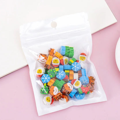 Assortment of 50 small cartoon erasers in pearlescent bags, showing fruit, animal, and holiday designs.