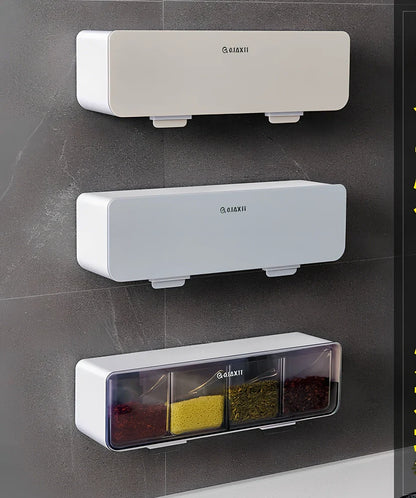 Wall-mounted plastic spice box set with multiple compartments and measuring spoon in kitchen