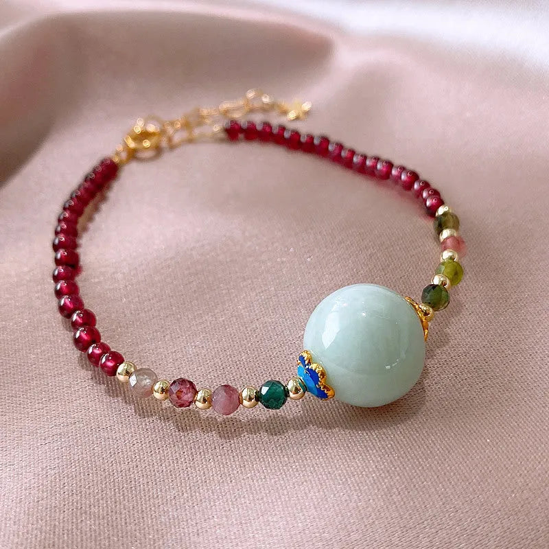 Aquamarine coloured drop shape tourmaline bracelet with garnet electroplated finish