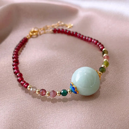 Aquamarine coloured drop shape tourmaline bracelet with garnet electroplated finish