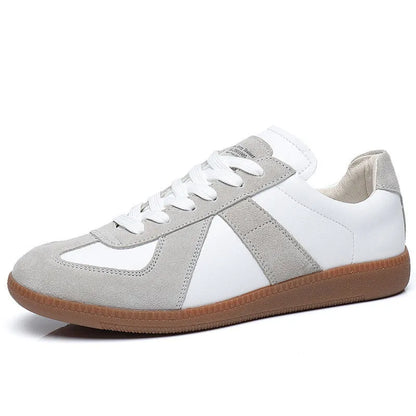 White Japanese-style retro low-top sneakers with round toe and flat rubber sole on a plain background.