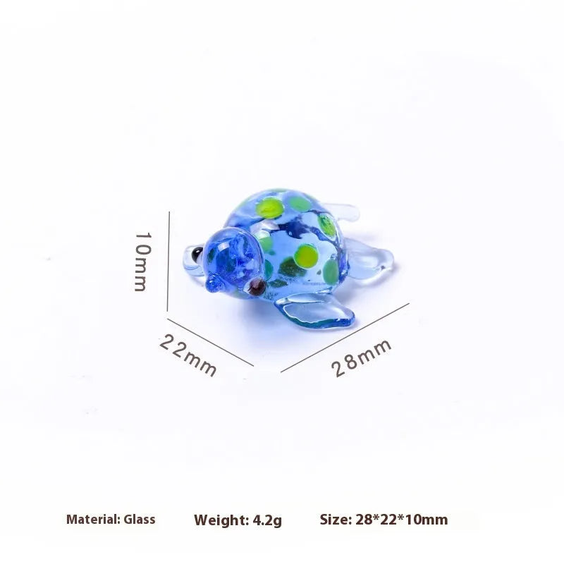 Geometric glass turtle figurine ornament on a desk, shown in blue head and blue shell colour variant.