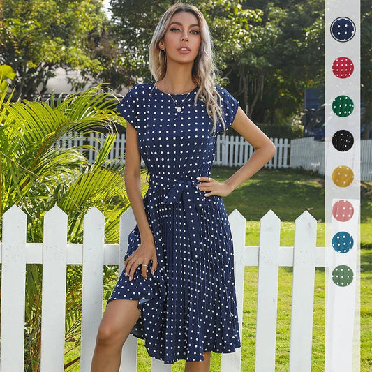 Elegant polka dot midi dress with short sleeves, made of soft viscose fabric and featuring a flattering pleated A-line skirt