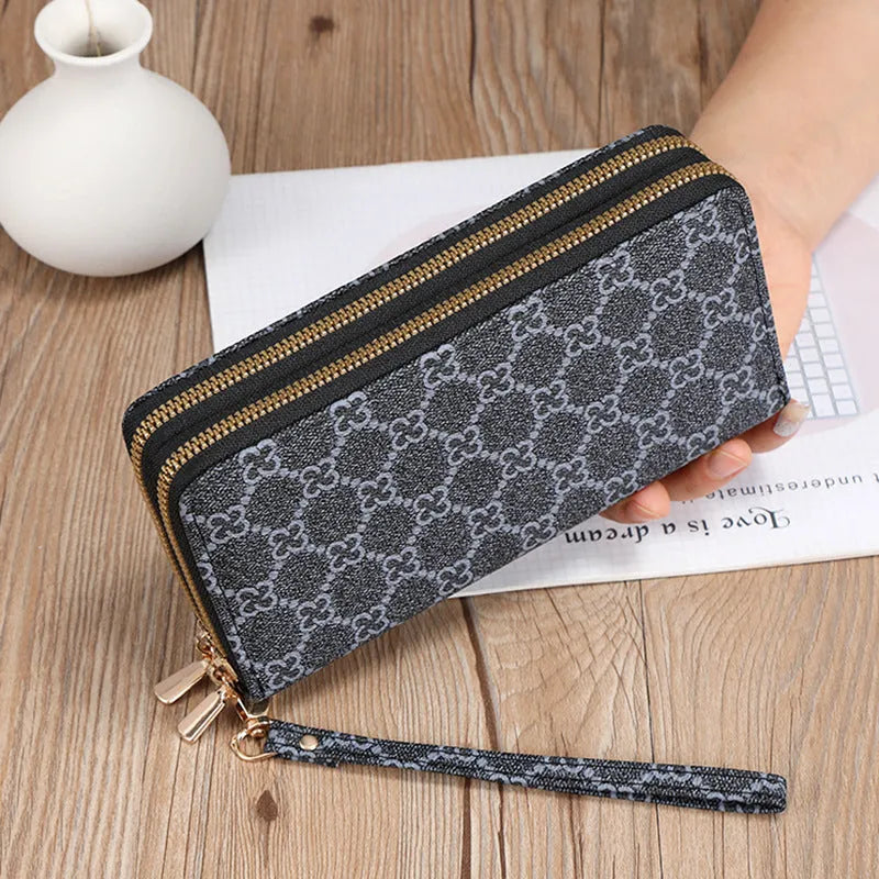 Long black retro-style PU leather wallet clutch with a printed pattern, showing a mobile phone pocket and a zippered coin purse.
