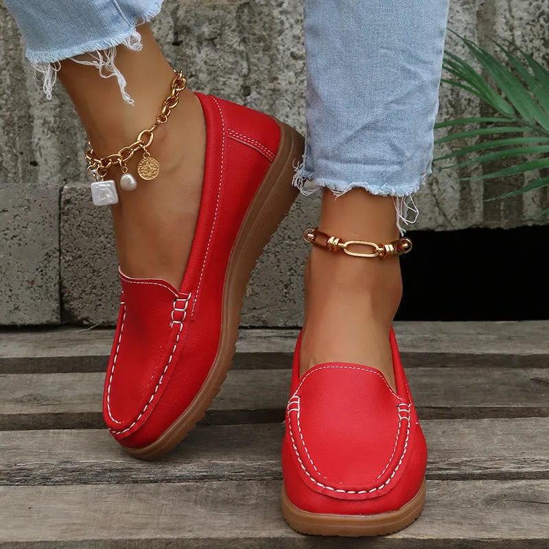 Women's flat shoes with car suture detailing on PU leather upper, round toe, rubber sole, available in multiple colours