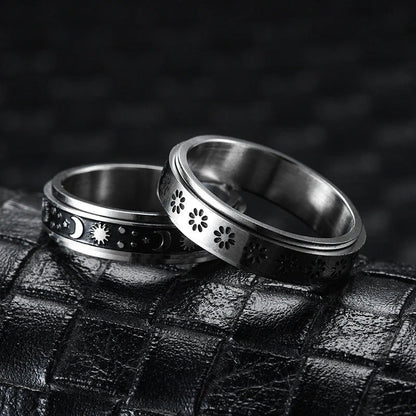 Stainless steel spinner ring with intricate moon and stars design
