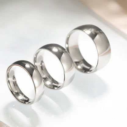 Silver titanium steel unisex ring with grinding texture on finger, showing different band width options.