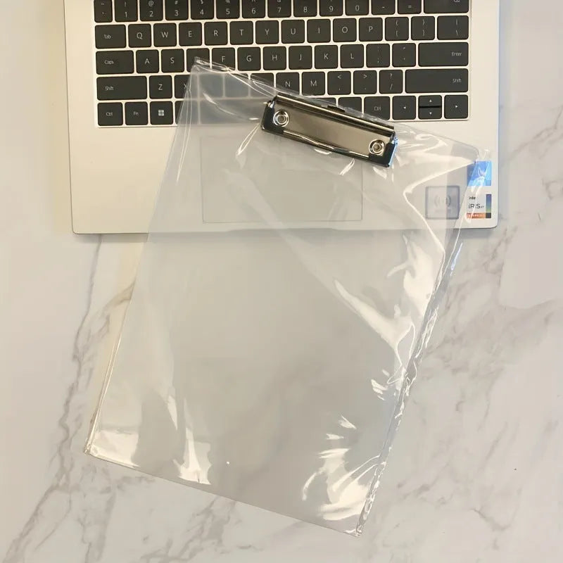 Transparent A4 writing board pad with metal flat clip in blue, alongside A5 size in red on a desk.