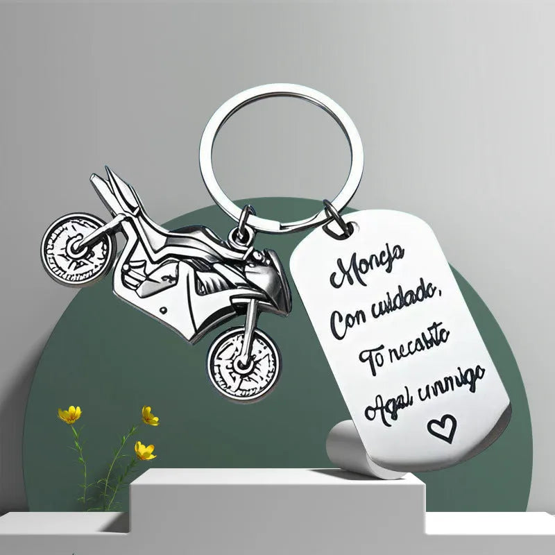Stainless steel minimalist motorcycle keychain in a flannel gift bag.