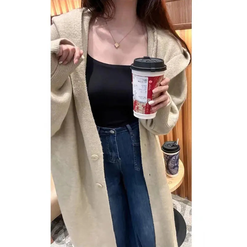 Women's Korean style hooded long knitted cardigan in oatmeal colour, showing loose fit and below-the-knee length