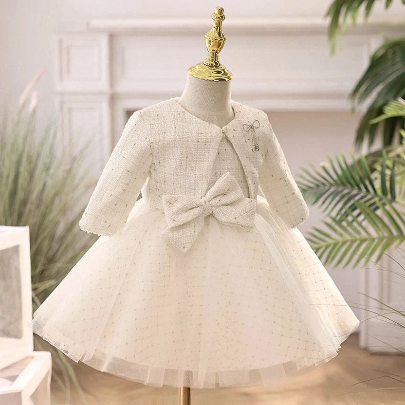 White long-sleeved flower girl wedding dress with princess styling on mannequin