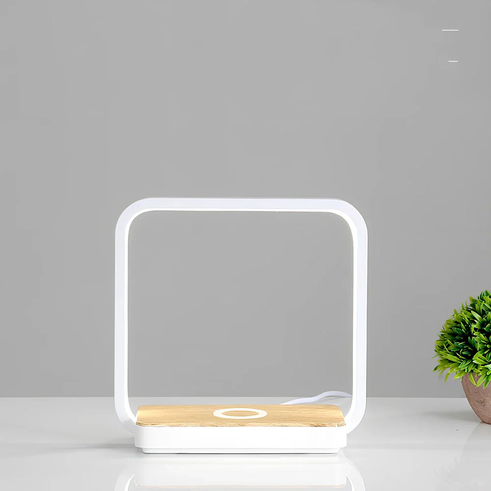 Modern bedside lamp with wireless charging pad and adjustable LED lighting in gold finish