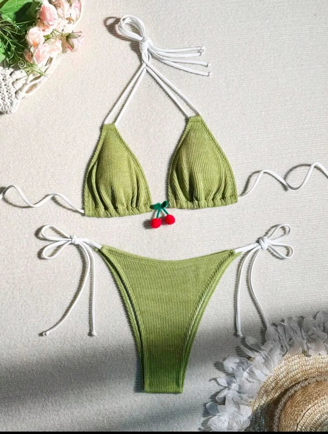 Solid colour briefs-style bikini swimsuit on a hanger, showing the top and pants.