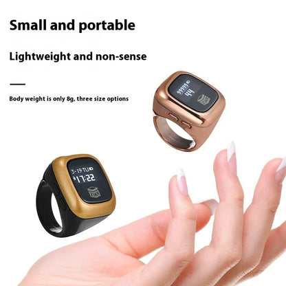 Al-Fatiha black electronic zikr counter on wrist showing digital display, with rose gold and silver colour options visible.