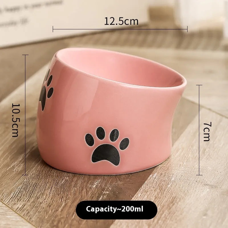 Ceramic cat bowl with high foot and cat's paw base in an oblique mouth design.