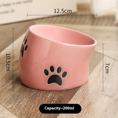 Ceramic cat bowl with high foot and cat's paw base in an oblique mouth design.