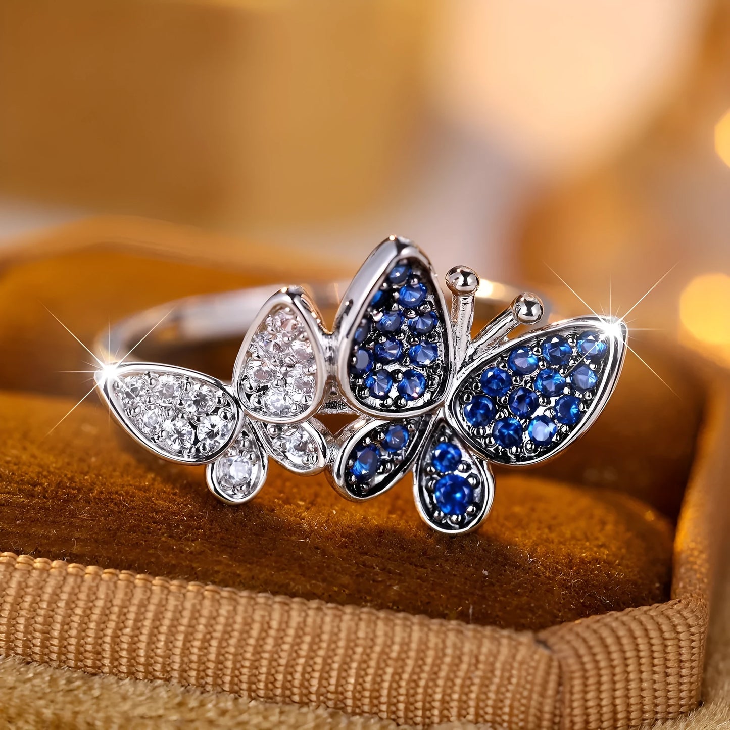 Silver-tone blue and white butterfly design ring for women on a white background.