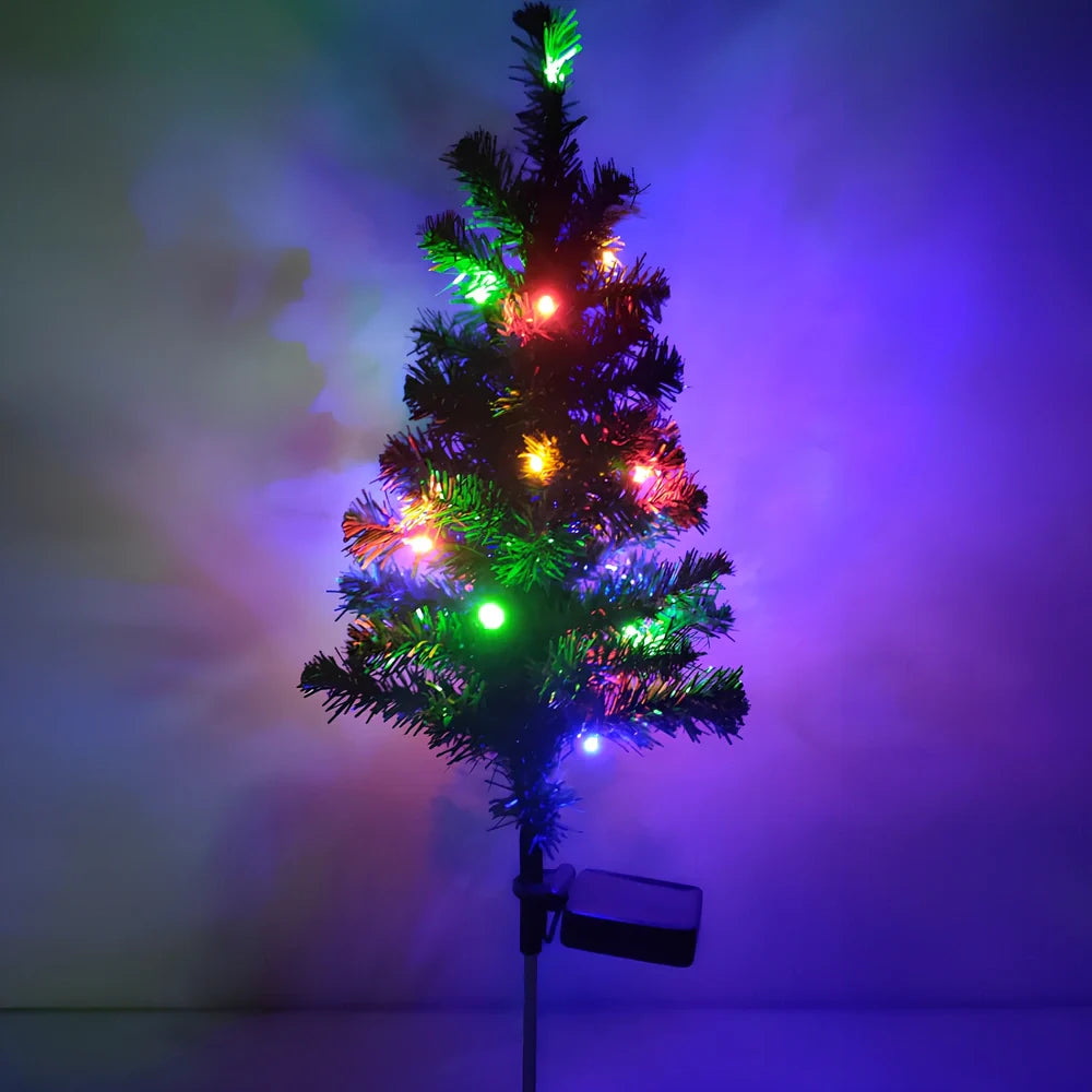 Solar-powered Christmas tree garden light with green ABS construction and warm white LED illumination