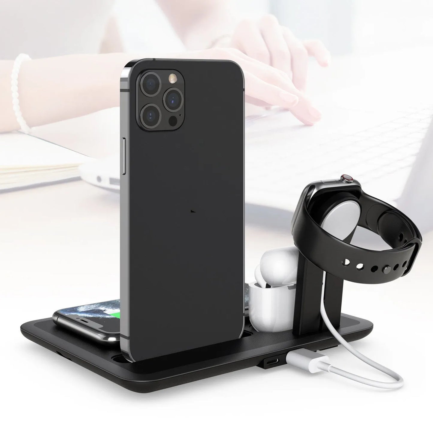 Black wireless charging bracket holding a phone at an angle, with USB cable and ports for watch and headphone charging