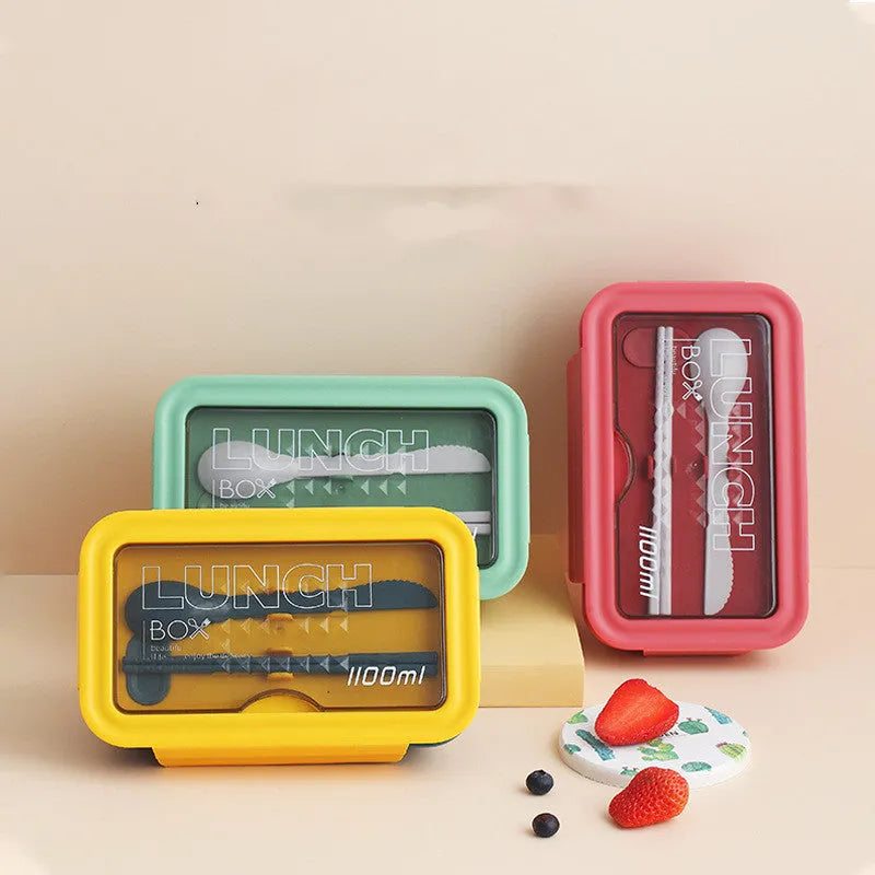 Green four-compartment plastic bento box with secure lid, showing internal partitions for separate food storage.