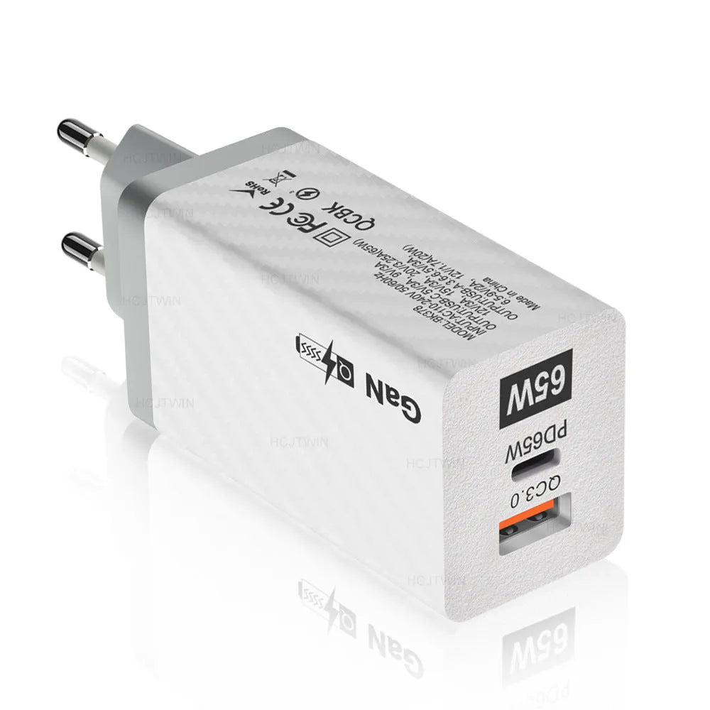 White or black GaN 65W universal laptop charger with USB-C port and compact design next to EU and US plugs