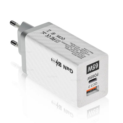 White or black GaN 65W universal laptop charger with USB-C port and compact design next to EU and US plugs