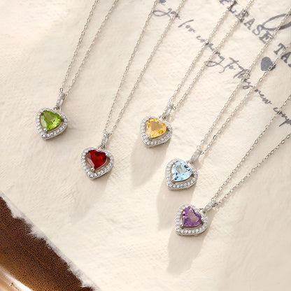 Sterling silver heart pendant necklace with a coloured gemstone on an adjustable chain.