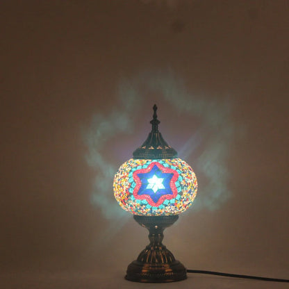 Glass table lamp with 150mm diameter shade and 330cm cord on wooden surface