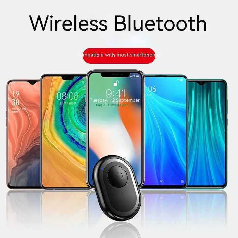 Small black wireless Bluetooth remote control for smartphone camera with self-timer function.