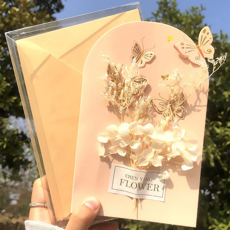 Handmade 3D pop-up greeting card with butterfly shape showing artificial flowers and hot stamping details