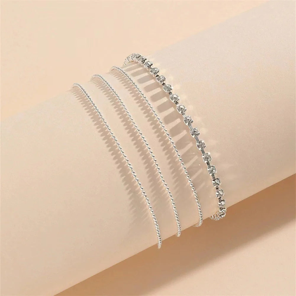 Women's geometric bead anklet with adjustable chain in gold and silver options.