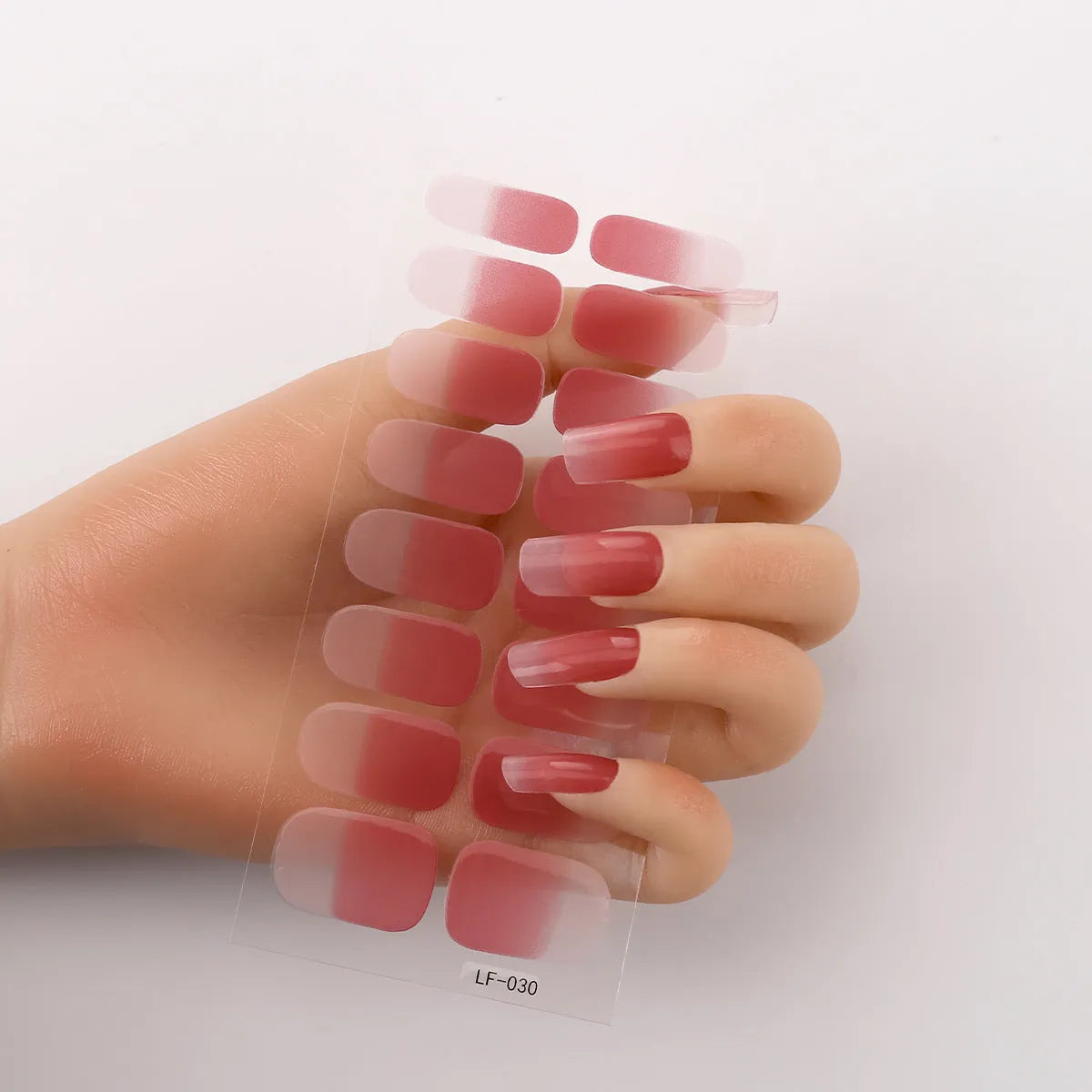 Sheet of 16 small design nail art stickers including cross, rose, tulip and marble patterns.