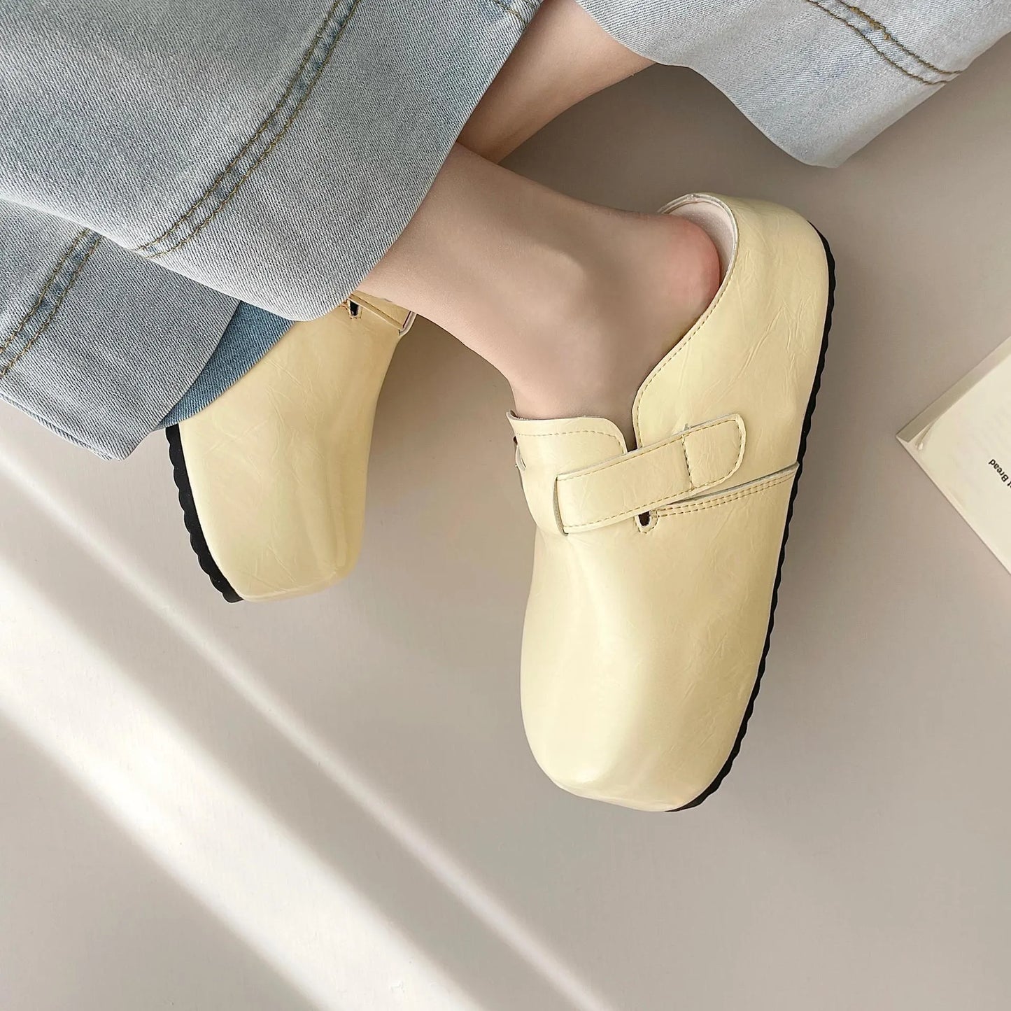 Flat buckle casual sneakers in beige, black, silver, and yellow colours, showing round toe and PU upper.