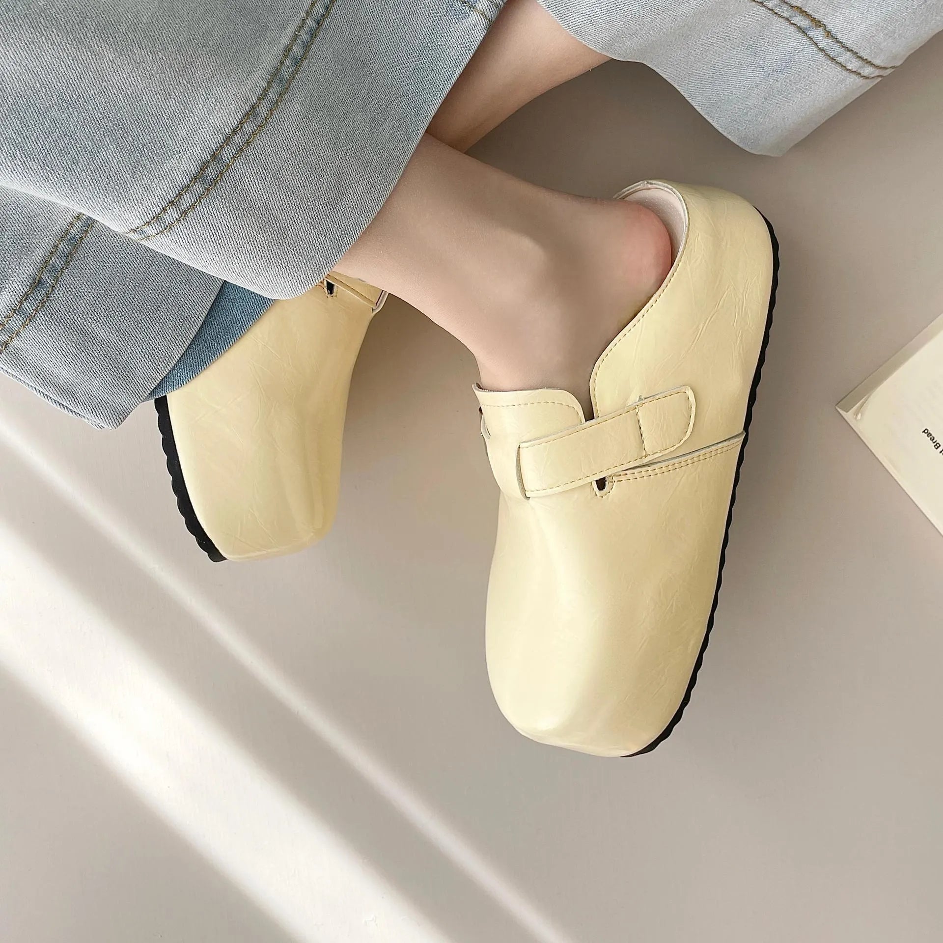 Flat buckle casual sneakers in beige, black, silver, and yellow colours, showing round toe and PU upper.